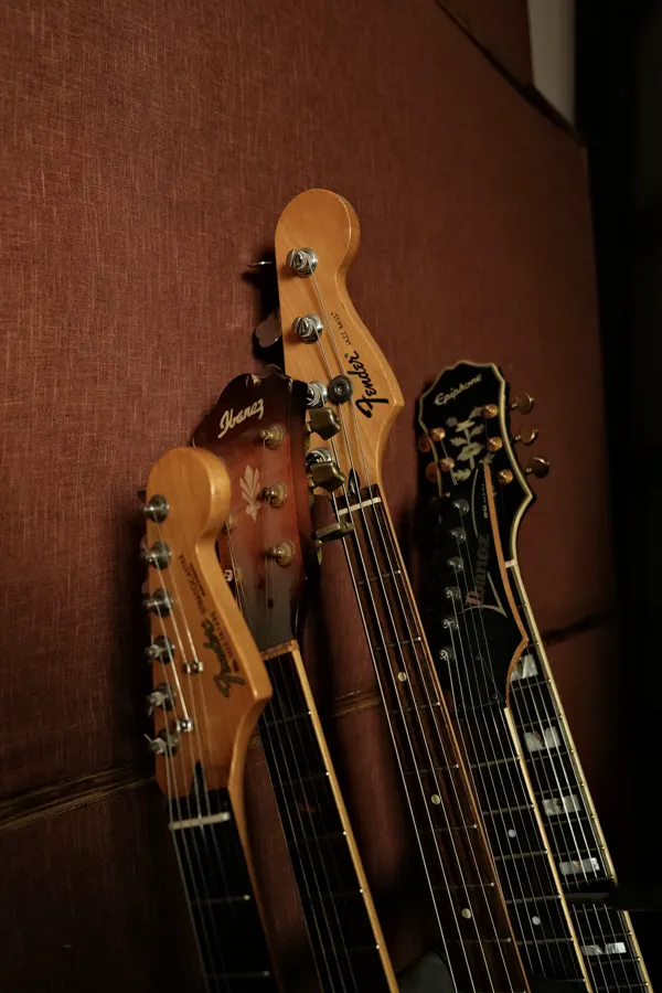 Guitar headstocks against the studio wall